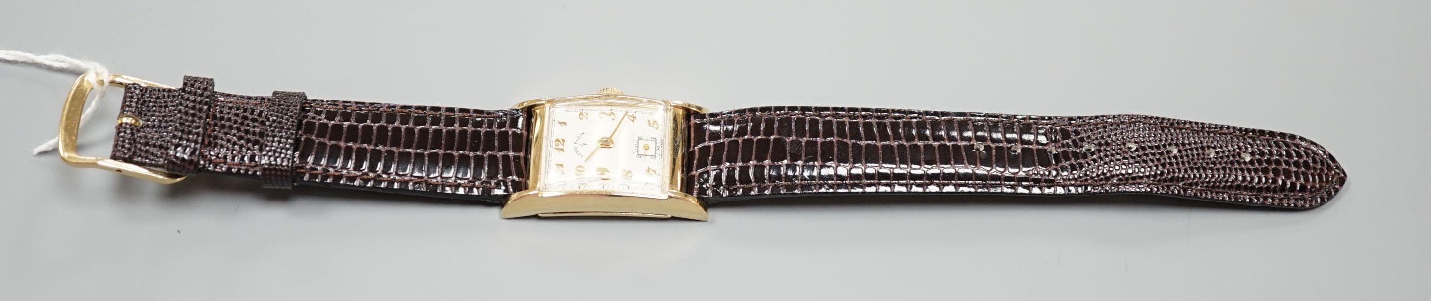 A gentleman's 1950's 14ct Lord Elgin manual wind wrist watch, with angular glass, Arabic dial and subsidiary seconds, on later leather strap, case diameter 23mm, gross weight 24.7 grams.